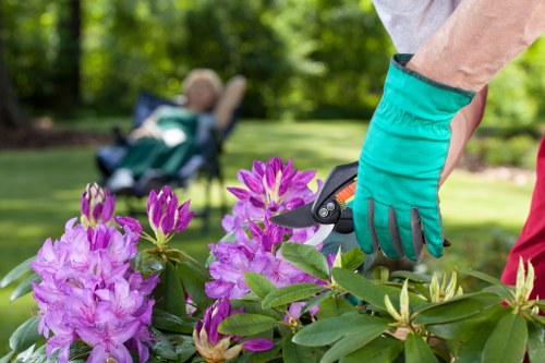 A gardener in Upminster Bridge using PPE on site