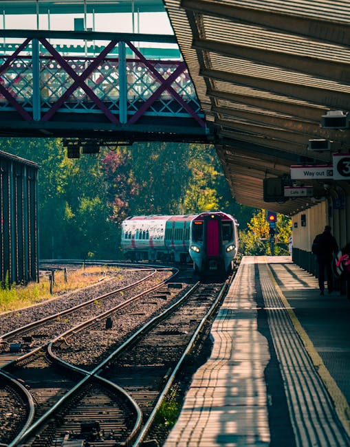 A view of a railway station platform near Upminster Bridge Station RM14, showing two set of train tracks running parallel along the platform with tactile paving along the edge for safety. The platform